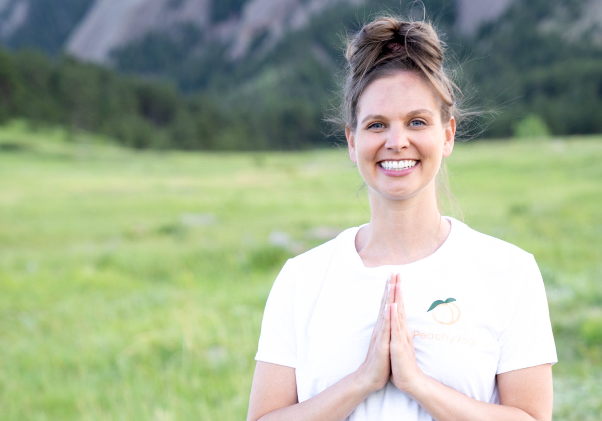 Smiling woman in namaste pose